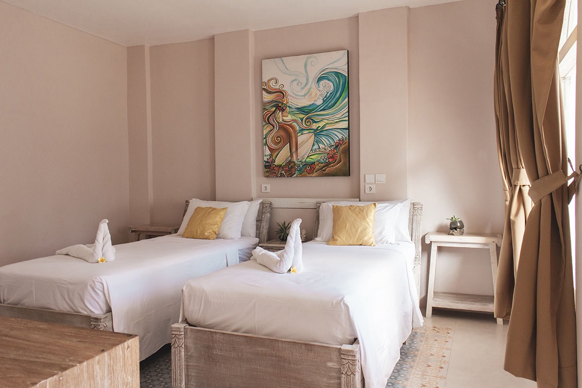 Bright Isla Indah room with twin beds and soft natural light.