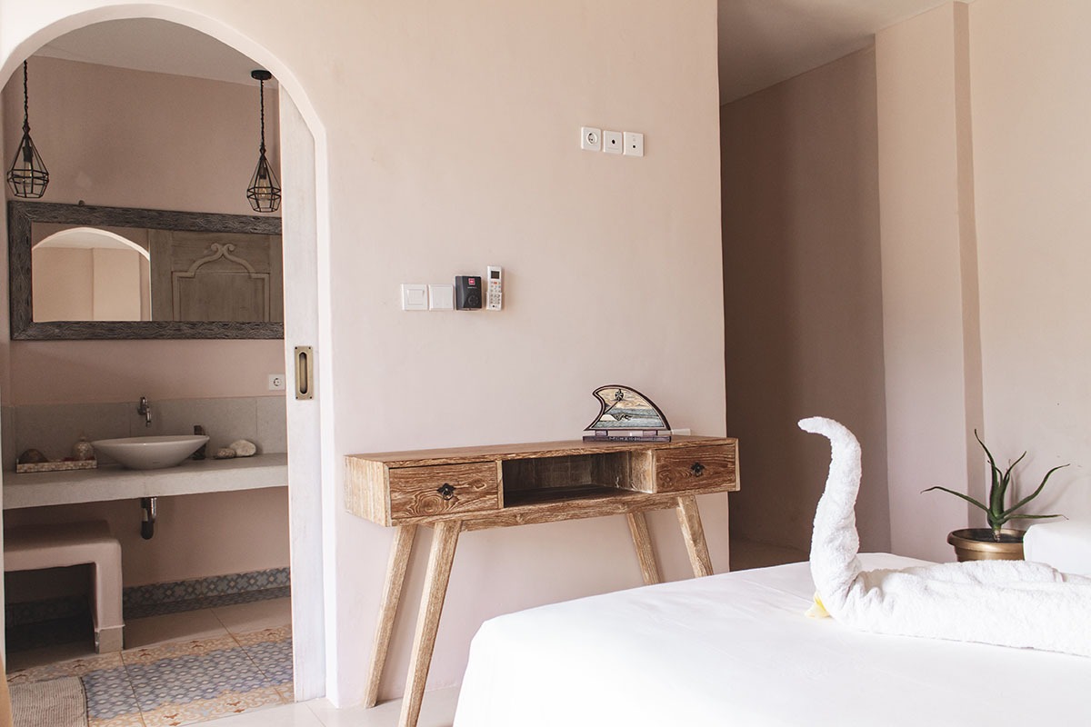 Isla Indah room detail with garden-facing calm and natural textures.
